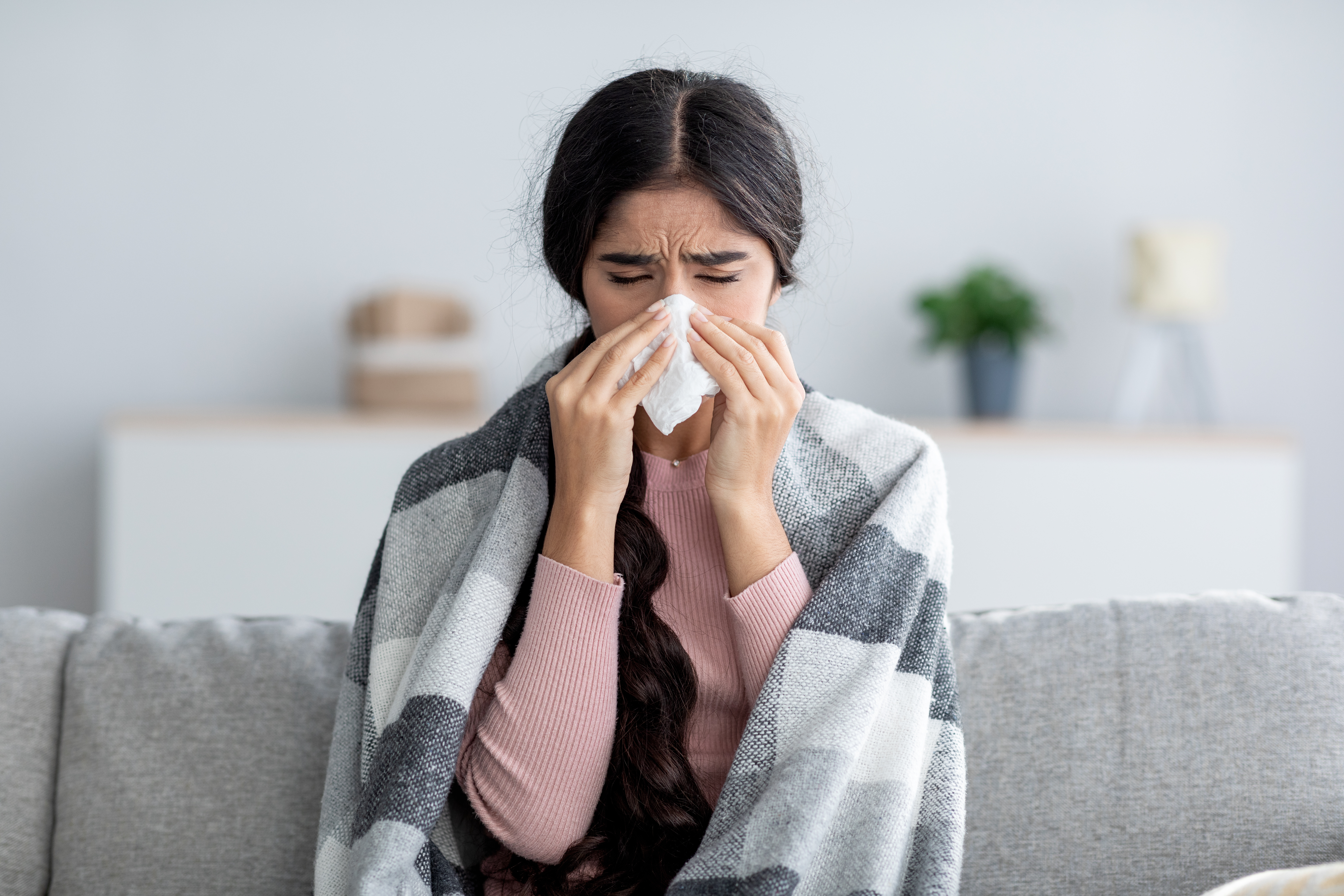 woman sick at home with ovid-19 or the flu
